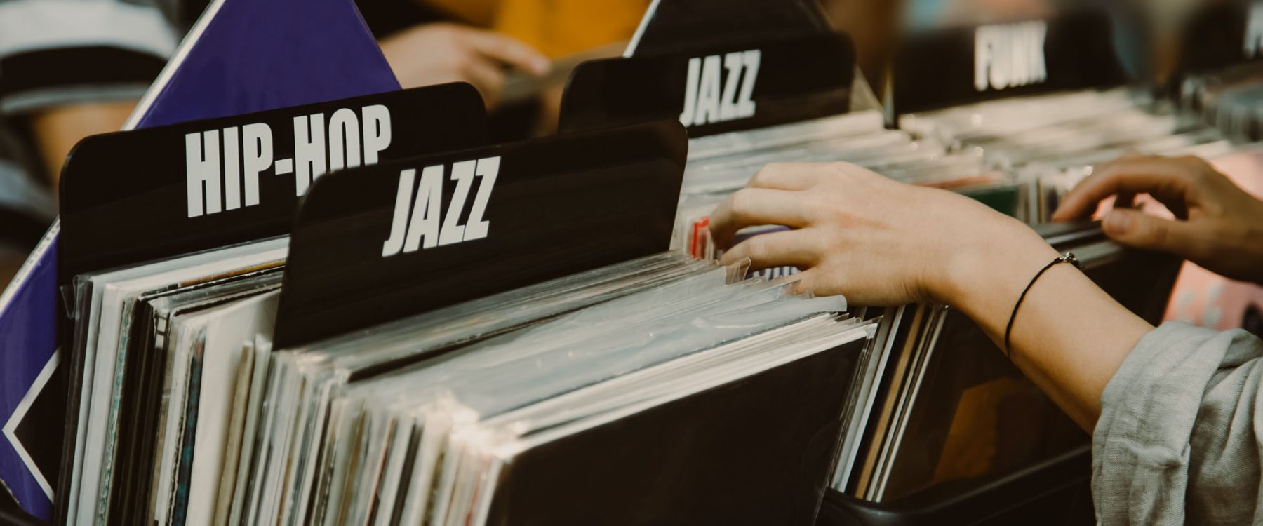 Woman is choosing a vinyl record in a musical store