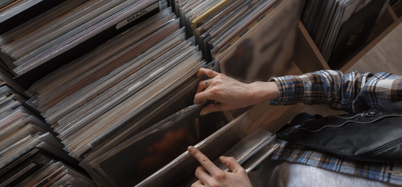female hands browsing vinyl records in a store